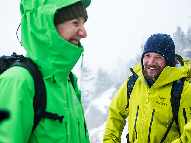 Two people standing in the snow wearing Arcteryx.